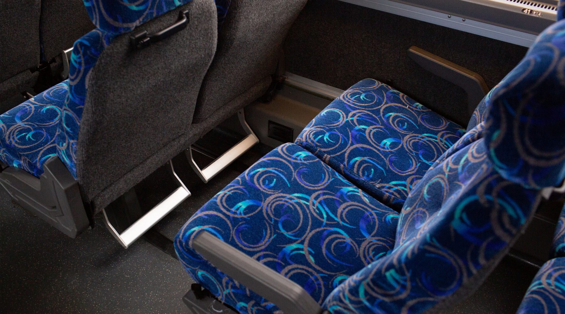 Bus seats with armrests and footrests