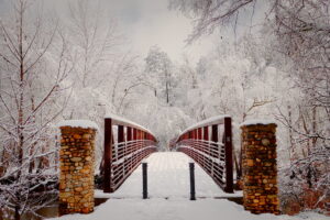 old mill park woodstock bridge covered in snow